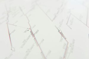 electrician reviewing electrical certification documents on desk with blueprint background